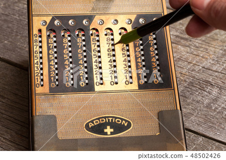 Vintage manual calculator from 1930s with a stylus 48502426