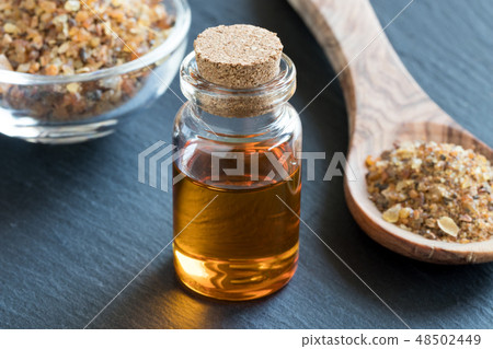 A bottle of myrrh essential oil with myrrh resin 48502449