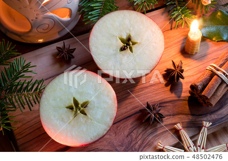 Christmas decoration - halved apple, candle, spice 48502476