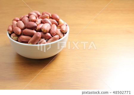 A peanut with a heap of peppers. A peanut with a heap of peppers. 48502771