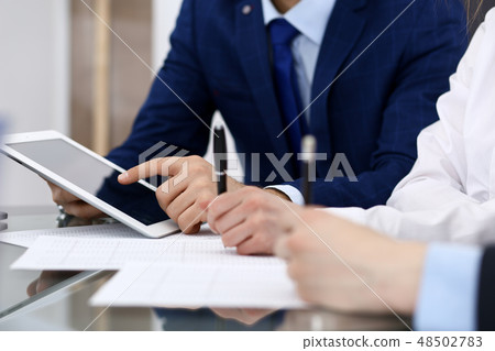 Businessman using laptop at meeting, closeup of hands. Business operations concept Businessman using laptop at meeting, closeup of hands. Business operations concept 48502783