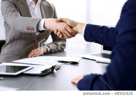 Business people shaking hands, finishing up a meeting. Papers signing, agreement and lawyer 48502820
