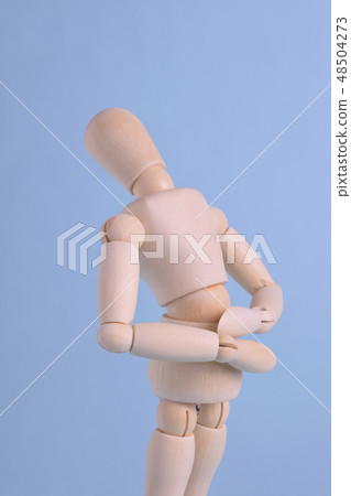 Wooden dolls with low back pain Wooden dolls with low back pain 48504273