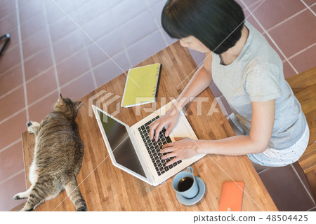 working at home with her cat 48504425