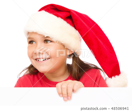 Little girl in santa hat is holding blank board Little girl in santa hat is holding blank board 48506941
