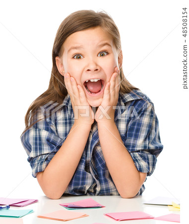 Girl is writing on color stickers using pen 48508154