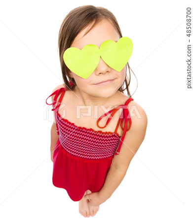 Little girl is holding hearts over her eyes Little girl is holding hearts over her eyes 48508700