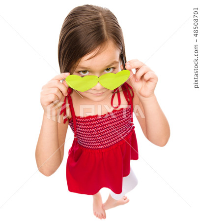 Girl is looking over her heart-shaped glasses 48508701