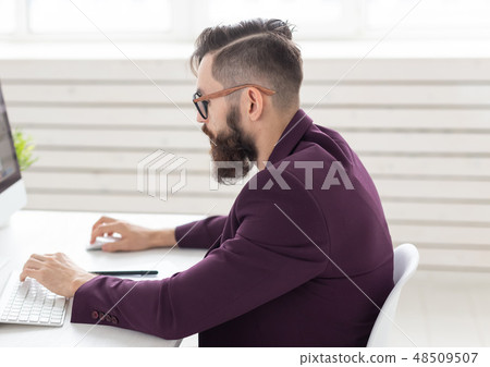 People and technology concept - Side view portrait of handsome man dressed in purple jacket working 48509507