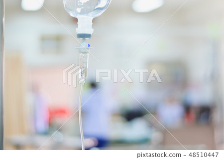 Medical saline iv drip close up with infusion pump in hospital, Saline intravenious on blurred Medical saline iv drip close up with infusion pump in hospital, Saline intravenious on blurred 48510447