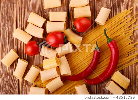 pasta on the wooden chili, pepper, garlic pasta on the wooden chili, pepper, garlic 48513759