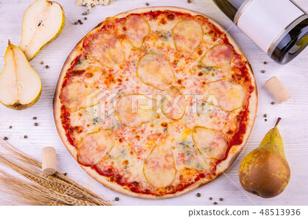Pear pizza, is served with white wine and crude Do 48513936