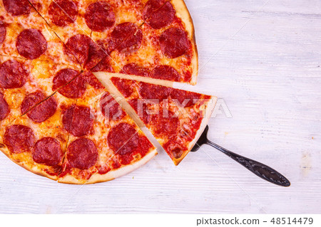 The pizza cut a la carte with salami and cheese 48514479