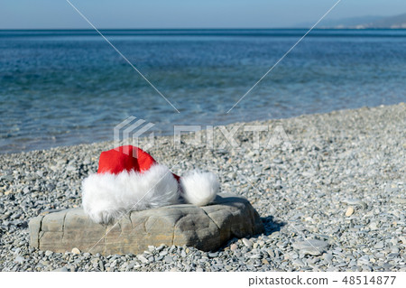 Santa Claus hat lies on a large stone Santa Claus hat lies on a large stone 48514877