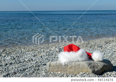 Santa Claus hat lies on a large stone Santa Claus hat lies on a large stone 48514878