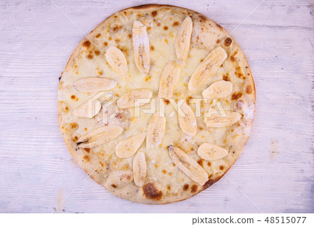 Pizza sweet with bananas and icing sugar Pizza sweet with bananas and icing sugar 48515077
