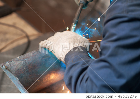 Blacksmith soldering a metal plate in workshop Blacksmith soldering a metal plate in workshop 48515279