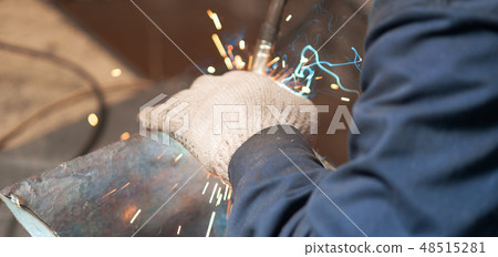 Blacksmith soldering a metal plate in workshop Blacksmith soldering a metal plate in workshop 48515281
