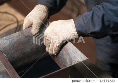 Blacksmith soldering a metal plate shot from above Blacksmith soldering a metal plate shot from above 48515288
