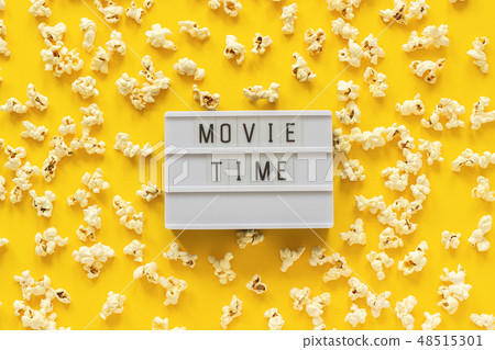 Scattered popcorn and lightbox text Movie time Scattered popcorn and lightbox text Movie time 48515301