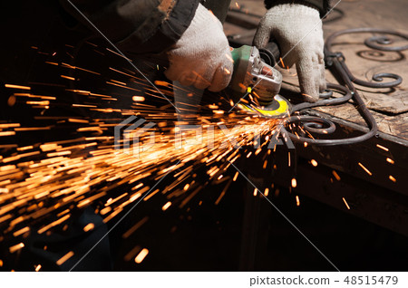 Blacksmith Polishes Metal Products Using A Grinding Machine 48515479