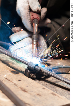 Blacksmith Polishes Metal Products Using A Grinding Machine Blacksmith Polishes Metal Products Using A Grinding Machine 48515499