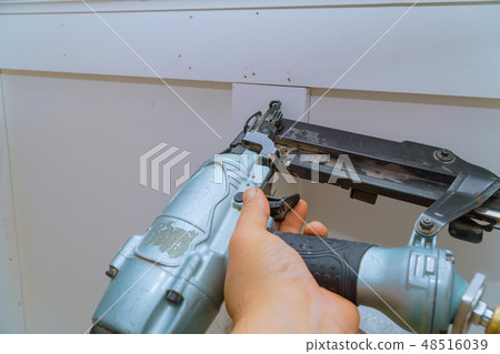 Carpenter brad using nail gun Moulding trim 48516039