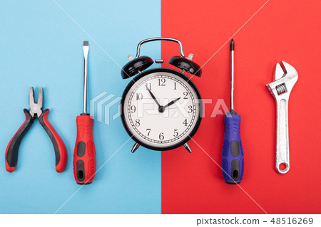 set of tools with alarm clock isolated on blue-red background 48516269