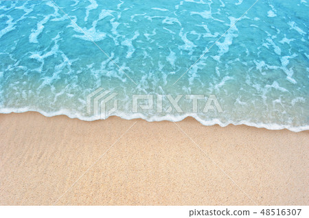 Soft blue ocean wave on clean sandy beach Soft blue ocean wave on clean sandy beach 48516307