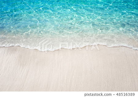 Soft blue ocean wave on clean white sandy beach 48516389