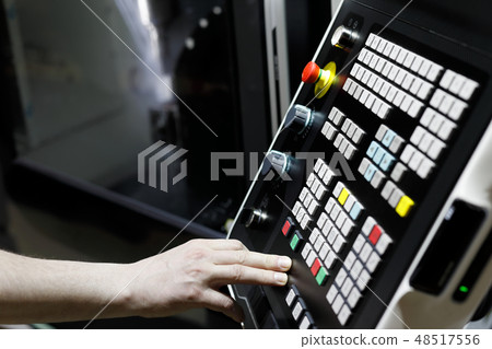 CNC lathe machine operator at work CNC lathe machine operator at work 48517556