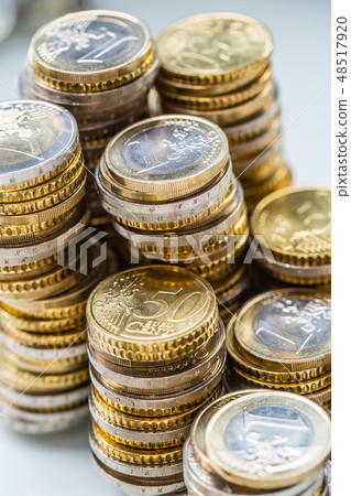 Towers with euro coins stacked together - close-up Towers with euro coins stacked together - close-up 48517920