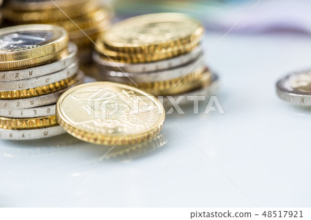 Towers with euro coins stacked together - close-up Towers with euro coins stacked together - close-up 48517921