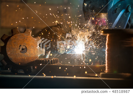 Welder is welding metal part in factory Welder is welding metal part in factory 48518987