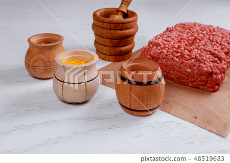 Raw minced meat ingredients on paper with onion Raw minced meat ingredients on paper with onion 48519683
