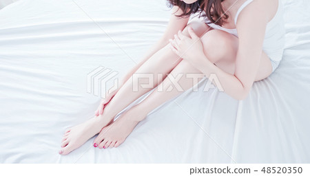 asian woman touch her leg asian woman touch her leg 48520350