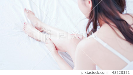 asian woman touch her leg asian woman touch her leg 48520351