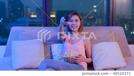 woman watch tv with popcorn woman watch tv with popcorn 48520371