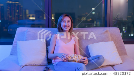 woman watch comedy with popcorn 48520372