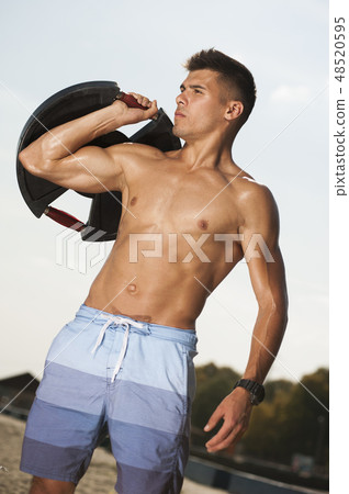 Athletic young handsome with naked body on the beach Athletic young handsome with naked body on the beach 48520595