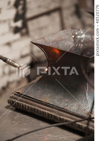 Close up of soldering of metal plate in workshop Close up of soldering of metal plate in workshop 48520776