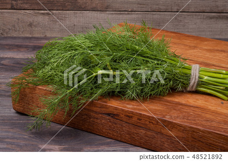 bunch of dill on wooden background 48521892