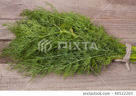 bunch of dill on wooden background 48522203