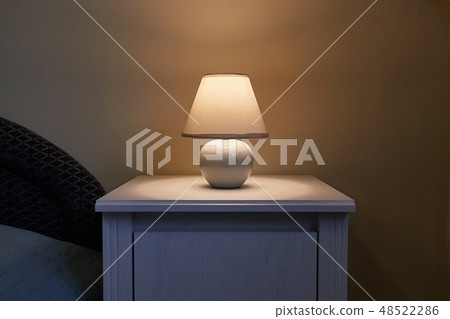Lamp on a nightstand Lamp on a nightstand 48522286