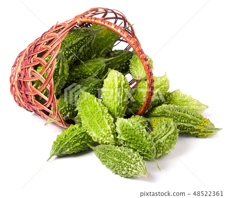 bitter melon or momordica in a wicker basket isolated on white background 48522361