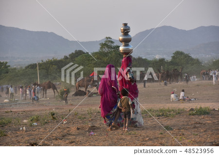 Indian family living in the Indian Pushkar Desert Families carrying aquarium wearing surrey camel gathering in the desert Indian family living in the Indian Pushkar Desert Families carrying aquarium wearing surrey camel gathering in the desert 48523956