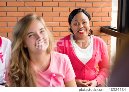 Multiethnic group of women meeting for breast cancer awareness c 48524584