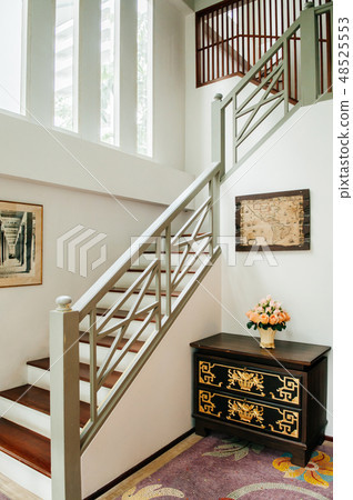 Oriental home with wooden furniture and stairwell 48525553