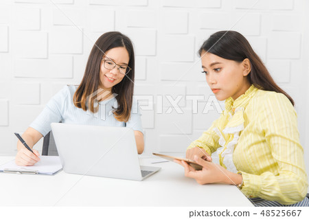 Two Asian architect ladies at office 48525667