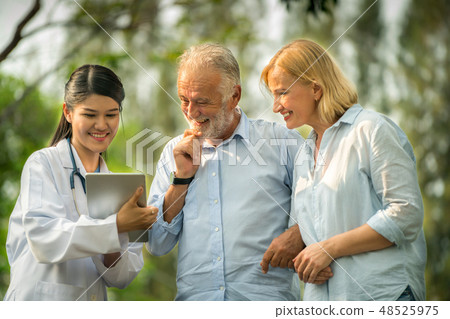 Senior couple talking to nurse or caregiver. 48525975